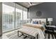 Inviting bedroom boasts a large window with a city view, complemented by stylish decor and comfortable furnishings at 855 Peachtree Ne St # 2913, Atlanta, GA 30308