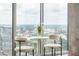 City view from an eating nook with bright white tulip table and plush white chairs at 855 Peachtree Ne St # 2913, Atlanta, GA 30308
