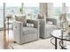 Bright and comfortable seating area with modern gray swivel chairs and city views at 855 Peachtree Ne St # 2913, Atlanta, GA 30308