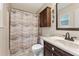 Bathroom with vanity, toilet, shower with curtain, and overhead storage at 860 The Cir, Lawrenceville, GA 30043