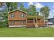 Charming two-story home featuring wood siding, a covered porch and a well-manicured lawn at 860 The Cir, Lawrenceville, GA 30043