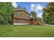 Side view of a cozy two-story house showcasing a green lawn and mature trees in the background at 860 The Cir, Lawrenceville, GA 30043