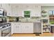 Bright kitchen with stainless steel appliances, white cabinets, and a granite countertop at 860 The Cir, Lawrenceville, GA 30043
