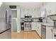 Well-lit kitchen with white cabinets, stainless steel appliances, and granite countertops at 860 The Cir, Lawrenceville, GA 30043
