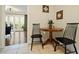 Dining area featuring a round wood table, two chairs, and doors that lead to a patio at 869 Briarcliff Ne Rd # B20, Atlanta, GA 30306