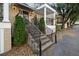 Exterior shot of stairs leading up to a porch with decorative black metal railings and manicured greenery at 869 Briarcliff Ne Rd # B20, Atlanta, GA 30306