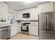 Well-lit kitchen featuring stainless steel appliances and contrasting black-and-white backsplash at 869 Briarcliff Ne Rd # B20, Atlanta, GA 30306