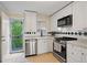 Updated kitchen features stainless appliances, white cabinetry, and access to the balcony at 869 Briarcliff Ne Rd # B20, Atlanta, GA 30306