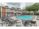Community pool area with plenty of seating and attractive red brick facades and white balconies at 869 Briarcliff Ne Rd # B20, Atlanta, GA 30306