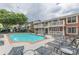 Beautiful community pool with comfortable seating and red brick townhomes with white balconies at 869 Briarcliff Ne Rd # B20, Atlanta, GA 30306