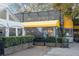 Charming restaurant with outdoor seating, a wine shop sign, and lush greenery at 869 Briarcliff Ne Rd # B20, Atlanta, GA 30306