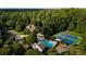 Community aerial view with swimming pool, tennis courts, and lush surrounding trees offering privacy at 443 Langley Oaks Dr, Marietta, GA 30067