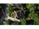 Aerial view of the home and backyard with stone patio nestled among mature trees and lush landscaping at 443 Langley Oaks Dr, Marietta, GA 30067