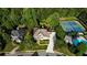 Aerial view featuring pool, tennis court, property, well manicured lawn and green surroundings at 443 Langley Oaks Dr, Marietta, GA 30067