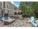 Spacious backyard featuring a stone fire pit, outdoor seating, and a lush green landscape at 443 Langley Oaks Dr, Marietta, GA 30067