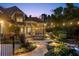 Backyard patio at twilight with a water feature, dining, and landscape lighting at 443 Langley Oaks Dr, Marietta, GA 30067