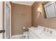 Bathroom features white vanity, toilet, shower with glass door, and earth-toned wallpaper at 443 Langley Oaks Dr, Marietta, GA 30067