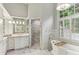 Bright bathroom features a soaking tub, walk-in shower, and lots of natural light at 443 Langley Oaks Dr, Marietta, GA 30067
