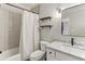 Bathroom with marble vanity, toilet, shower with curtain, and black and white accents at 443 Langley Oaks Dr, Marietta, GA 30067