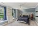 Bedroom with carpet, blue walls, a ceiling fan, and a dresser next to a window at 443 Langley Oaks Dr, Marietta, GA 30067