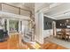 Elegant foyer featuring a curved staircase, hardwood floors, and open view of dining room at 443 Langley Oaks Dr, Marietta, GA 30067
