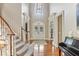 Grand foyer with high ceilings, curved staircase, and elegant lighting fixture at 443 Langley Oaks Dr, Marietta, GA 30067