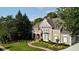 Beautiful front exterior with stone accents, arched porch, and meticulously landscaped front yard at 443 Langley Oaks Dr, Marietta, GA 30067