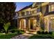 Charming front porch with stone archways, inviting entrance, and lush landscaping at 443 Langley Oaks Dr, Marietta, GA 30067