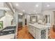 Gourmet kitchen with island, stainless steel appliances, wine rack, and hardwood floors at 443 Langley Oaks Dr, Marietta, GA 30067