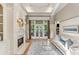 Bright living room with fireplace, built-in shelving, and access to the outdoors at 443 Langley Oaks Dr, Marietta, GA 30067