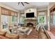 Cozy living room features a stone fireplace, built-in shelving, and lots of natural light at 443 Langley Oaks Dr, Marietta, GA 30067