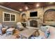 Inviting outdoor living space with stone fireplace, comfortable seating, and a ceiling fan at 443 Langley Oaks Dr, Marietta, GA 30067