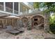 Inviting outdoor patio with fireplace, stone accents, and lounge chairs at 443 Langley Oaks Dr, Marietta, GA 30067