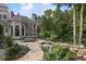 Charming patio with a stone walkway, outdoor dining area, and a tranquil water feature at 443 Langley Oaks Dr, Marietta, GA 30067
