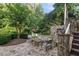 Outdoor patio with stone pavers, comfortable seating, and lush greenery at 443 Langley Oaks Dr, Marietta, GA 30067