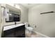 Contemporary bathroom featuring a sleek black vanity, modern fixtures, and neutral tile flooring at 800 Peachtree Ne St # 8607, Atlanta, GA 30308