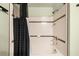 Clean white tiled bathtub and shower combination, enhanced by dark trim and a black shower curtain at 800 Peachtree Ne St # 8607, Atlanta, GA 30308