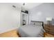 Comfortable bedroom with hardwood floors, a ceiling fan, and a closet with sliding mirror doors at 800 Peachtree Ne St # 8607, Atlanta, GA 30308