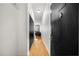 Apartment hallway featuring wood floors leading to a comfortable living space with ample natural light at 800 Peachtree Ne St # 8607, Atlanta, GA 30308