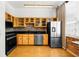 Kitchen featuring stainless steel appliances, wooden cabinets, a mosaic tile backsplash, and hardwood floors at 800 Peachtree Ne St # 8607, Atlanta, GA 30308