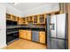 Kitchen featuring stainless steel appliances, wooden cabinets, a mosaic tile backsplash, and hardwood floors at 800 Peachtree Ne St # 8607, Atlanta, GA 30308