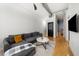 Bright living room with hardwood floors, modern lighting, and access to the bedroom at 800 Peachtree Ne St # 8607, Atlanta, GA 30308