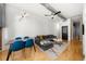 Open concept living room and dining area featuring hardwood floors, modern lighting, and large windows at 800 Peachtree Ne St # 8607, Atlanta, GA 30308