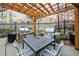 Outdoor grill area under a pergola with two stainless steel grills and a table with seating at 800 Peachtree Ne St # 8607, Atlanta, GA 30308