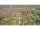 Areal view of home and wooded lot in Roswell, GA, with other homes nearby at 10845 Shallowford Rd, Roswell, GA 30075