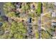 Aerial view of home near the lake, with a large wooded lot and a street view in Roswell, GA at 10845 Shallowford Rd, Roswell, GA 30075