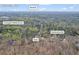 Roswell, GA aerial view of home with wooded surroundings and close to Crabapple Middle School and Shallowford Rd at 10845 Shallowford Rd, Roswell, GA 30075