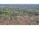 Aerial view of property, highlighting the surrounding woodlands and neighborhood in Roswell, GA at 10845 Shallowford Rd, Roswell, GA 30075
