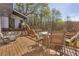 Spacious deck area with seating, ideal for outdoor dining and enjoying views of the backyard and wooded area at 10845 Shallowford Rd, Roswell, GA 30075