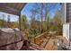 Expansive back deck with outdoor seating and a covered area, perfect for entertaining and enjoying the wooded views at 10845 Shallowford Rd, Roswell, GA 30075